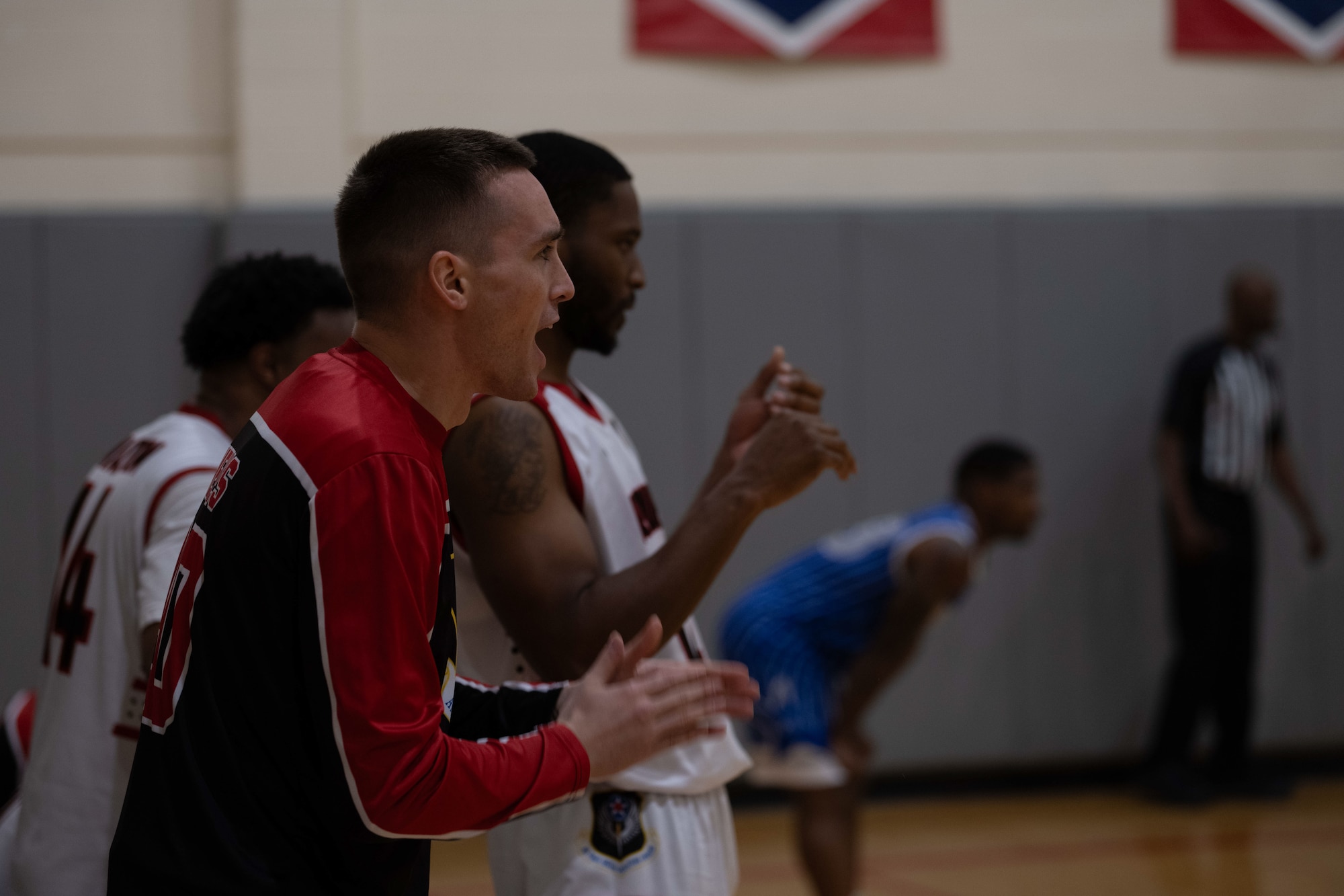 U.S. Airmen with the Hurlburt Field Air Commandos basketball team cheer during the Emerald Coast Rivalry game at Hurlburt Field, Florida, Jan. 10, 2025
