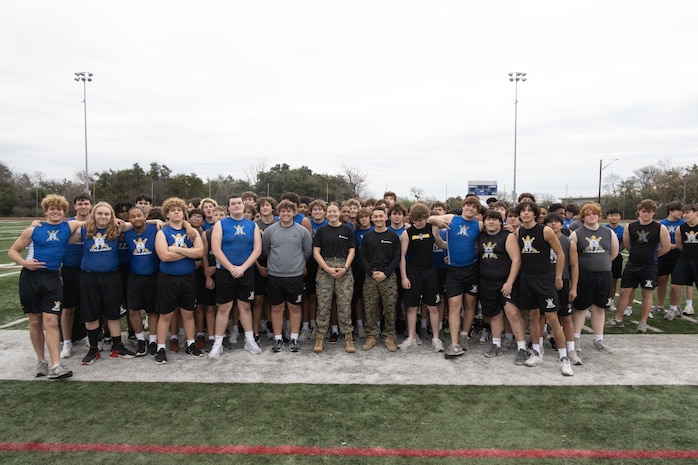 U.S. Marines with Recruiting Station Austin and students of Anderson High School, pose for a photo during a school visit at Anderson High School in Austin, Texas, Jan. 15, 2025. During this visit, the Marines conducted an Initial Strength Assessment with Anderson High School students. (U.S. Marine Corps photo by Cpl. Jose D. Cruz)