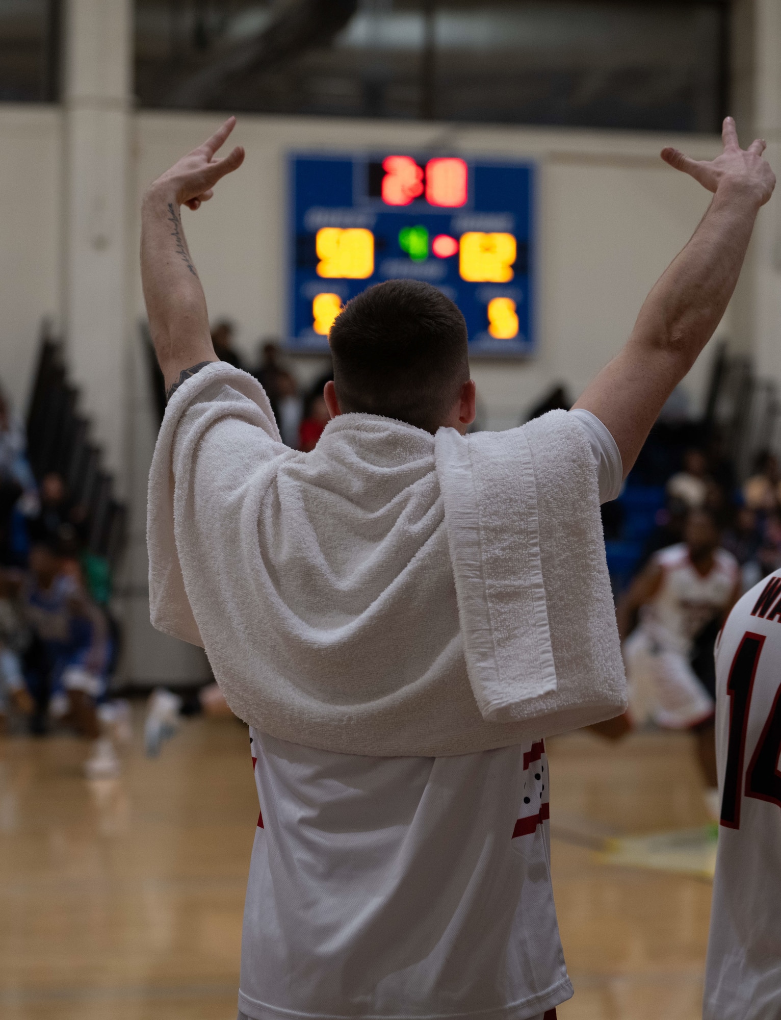 A U.S. Airman with the Hurlburt Field Air Commandos basketball team cheers during the Emerald Coast Rivalry game at Hurlburt Field, Florida, Jan. 10, 2025.