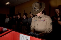 U.S. Marine Corps Drill Instructor Sgt. Natali Morenogardez with Receiving Company, Support Battalion, inspects recruits’ belongings during Hotel Company, 2nd Recruit Training Battalion, receiving event at Marine Corps Recruit Depot San Diego, California, Jan.13, 2025. During the receiving process, recruits are taken to the United States Organizations for accountability, checked for contraband, given haircuts, make a scripted phone call home, and issued gear required for training. (U.S. Marine Corps photo by Cpl. Sarah M. Grawcock)