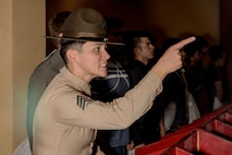 U.S. Marine Corps Drill Instructor Sgt. Natali Morenogardez with Receiving Company, Support Battalion, instructs a recruit during Hotel Company, 2nd Recruit Training Battalion, receiving event at Marine Corps Recruit Depot San Diego, California, Jan.13, 2025. During the receiving process, recruits are taken to the United States Organizations for accountability, checked for contraband, given haircuts, make a scripted phone call home, and issued gear required for training. (U.S. Marine Corps photo by Cpl. Sarah M. Grawcock)