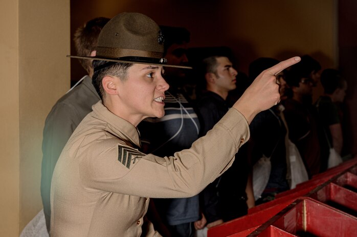 U.S. Marine Corps Drill Instructor Sgt. Natali Morenogardez with Receiving Company, Support Battalion, instructs a recruit during Hotel Company, 2nd Recruit Training Battalion, receiving event at Marine Corps Recruit Depot San Diego, California, Jan.13, 2025. During the receiving process, recruits are taken to the United States Organizations for accountability, checked for contraband, given haircuts, make a scripted phone call home, and issued gear required for training. (U.S. Marine Corps photo by Cpl. Sarah M. Grawcock)