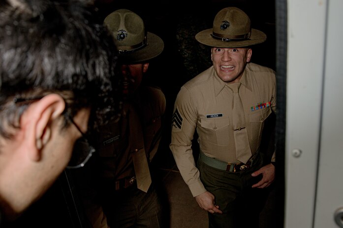 U.S. Marine Corps drill instructors with Receiving Company, Support Battalion, instruct recruits with Hotel Company, 2nd Recruit Training Battalion, off a bus as part of a receiving event at Marine Corps Recruit Depot San Diego, California, Jan. 13, 2025. During the receiving process, recruits are taken to the United States Organizations for accountability, checked for contraband, given haircuts, make a scripted phone call home, and issued gear required for training. (U.S. Marine Corps photo by Cpl. Sarah M. Grawcock)