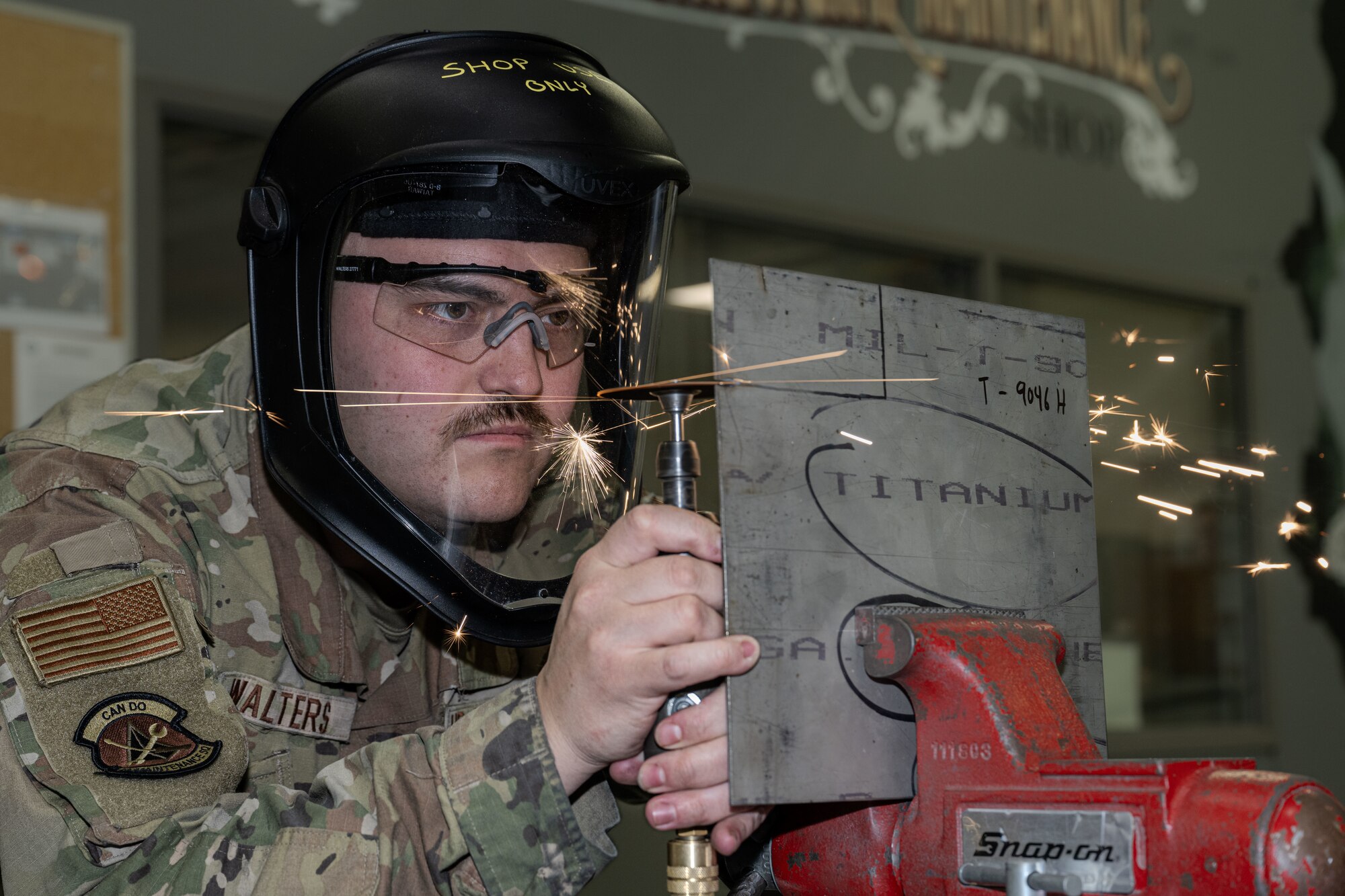 Senior Airman Justin Walters, 22nd Maintenance Squadron aircraft structural maintenance journeyman cuts through a sheet of titanium Jan. 15, 2025, at McConnell Air Force Base, Kansas. Walters used double eye protection to ensure safety from sparks. (U.S. Air Force photo by Airman 1st Class Paula Arce)