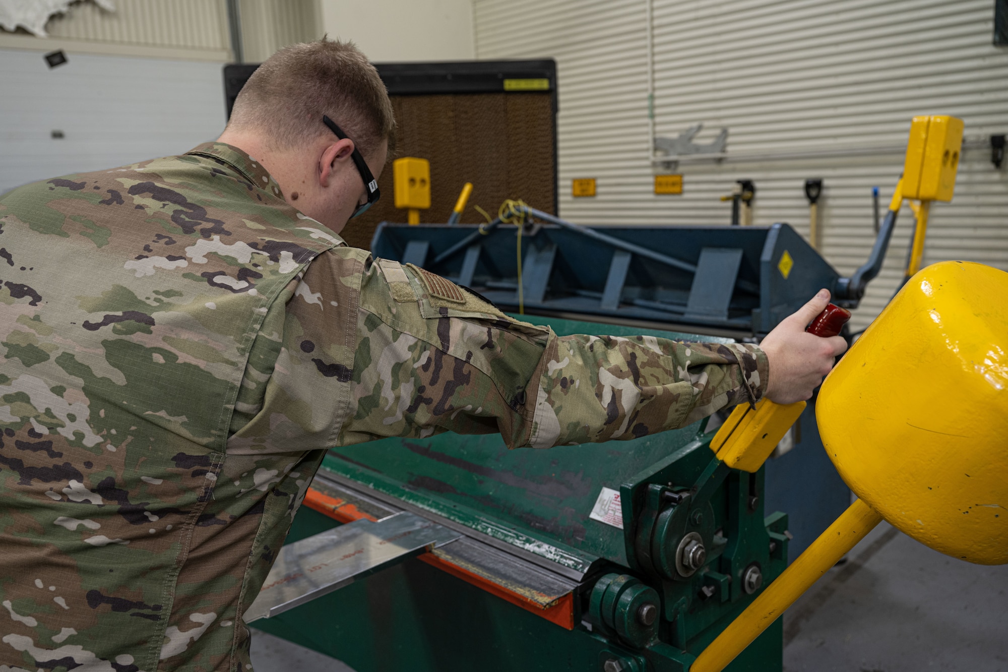 Senior Airman Logan Arnold, 22nd Maintenance Squadron aircraft structural maintenance journeyman, uses a cornice brake to bend a sheet of metal Jan. 15, 2025, at McConnell Air Force Base, Kansas. Logan is originally from Clarksdale, Missouri, and has been stationed at McConnell for over three years. (U.S. Air Force photos by Airman 1st Class Paula Arce)