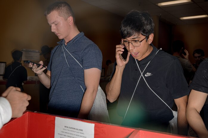 U.S. Marine Corps recruits with Hotel Company, 2nd Recruit Training Battalion, make a phone call home as part of the receiving process at Marine Corps Recruit Depot San Diego, California, Jan. 13, 2024. During the receiving process, recruits are taken to the United States Organizations for accountability, checked for contraband, given haircuts, make a scripted phone call home, and issued gear required for training. (U.S. Marine Corps photo by Cpl. Sarah M. Grawcock)