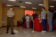 U.S. Marine Corps recruits with Hotel Company, 2nd Recruit Training Battalion, are briefed as part of a receiving event at Marine Corps Recruit Depot San Diego, California, Jan. 13, 2025. During the receiving process, recruits are taken to the United States Organizations for accountability, checked for contraband, given haircuts, make a scripted phone call home, and issued gear required for training. (U.S. Marine Corps photo by Cpl. Sarah M. Grawcock)