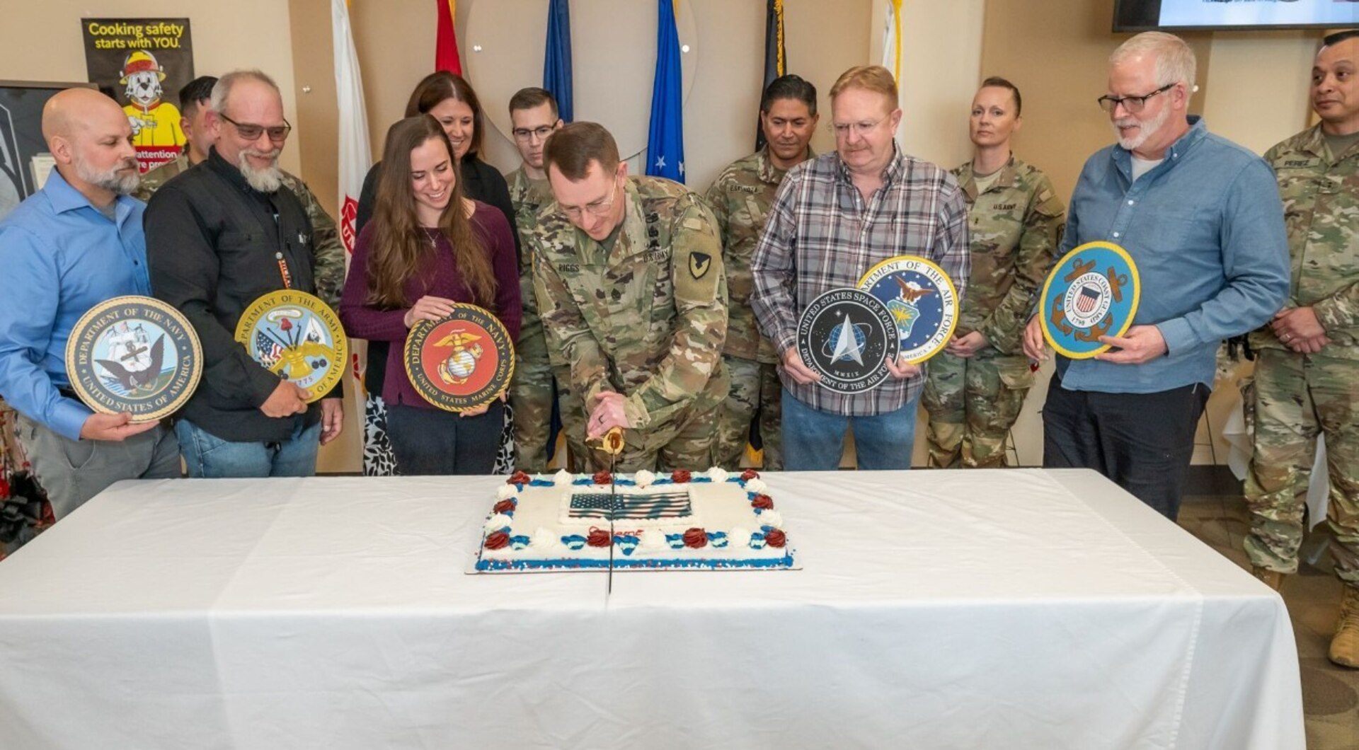 Photo of SGM cutting cake with a group of people
