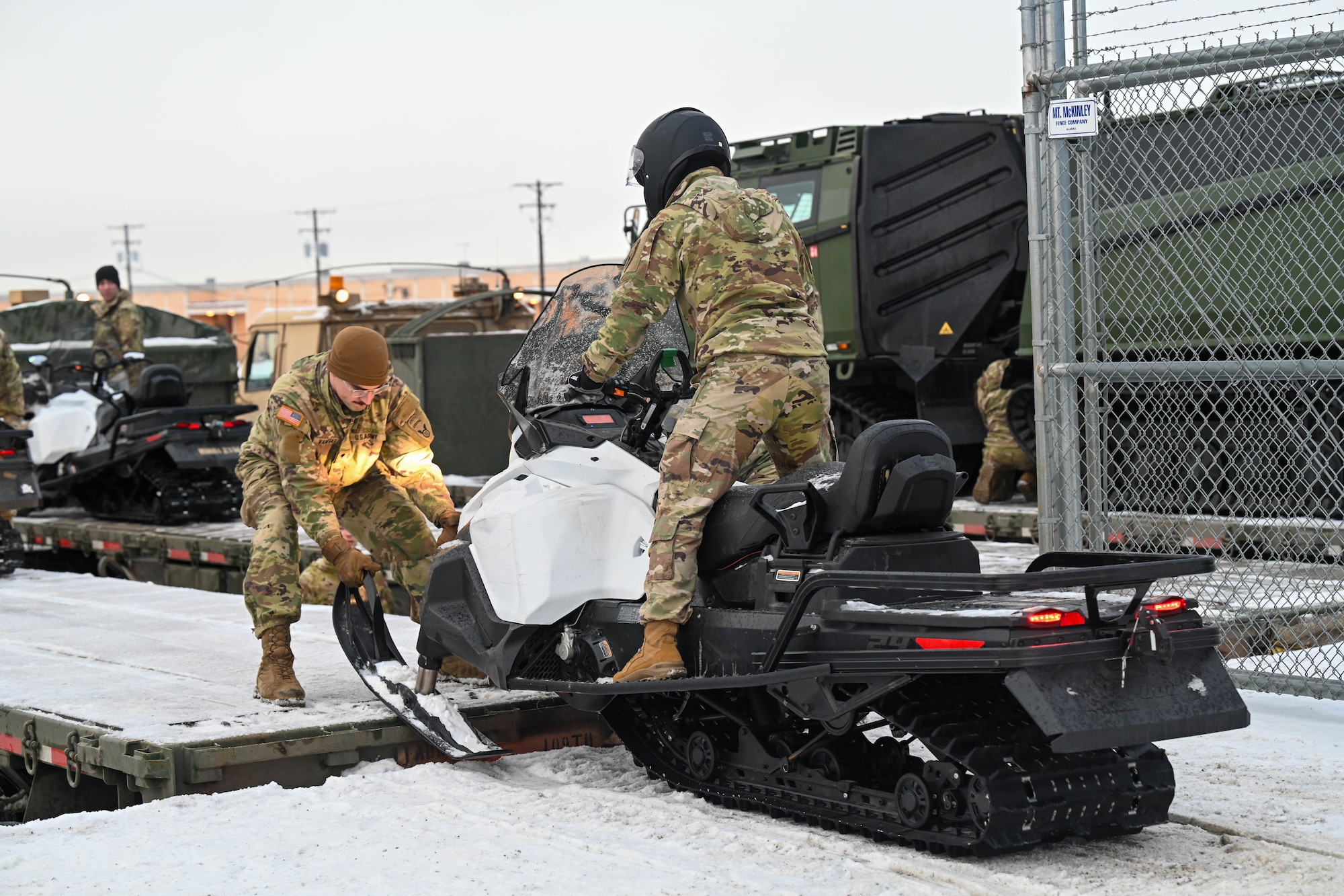 U.S. Army Soldiers from 2nd Brigade, 11th Airborne Division, work on securing equipment to a truck to carry equipment and prepare for the Joint Pacific Multinational Readiness Center exercise at Fort Wainwright on Joint Base Elmendorf-Richardson, Alaska, Jan 6, 2025.