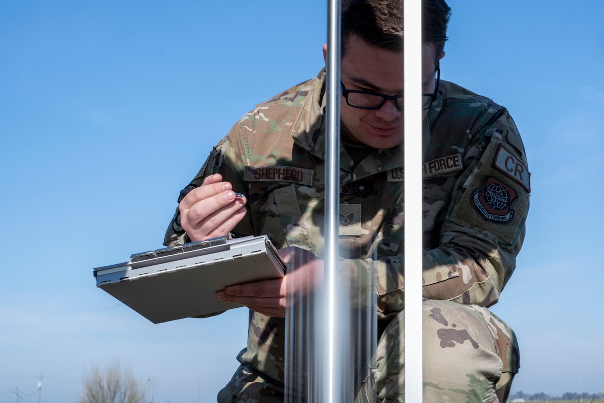 U.S. Air Force Staff Sgt. Wesley Shepherd, 821st Contingency Response Squadron landing zone safety officer, records soil integrity data from a dynamic cone penetrometer on an unprepared flight line in Rio Vista, California, Jan. 10, 2025.