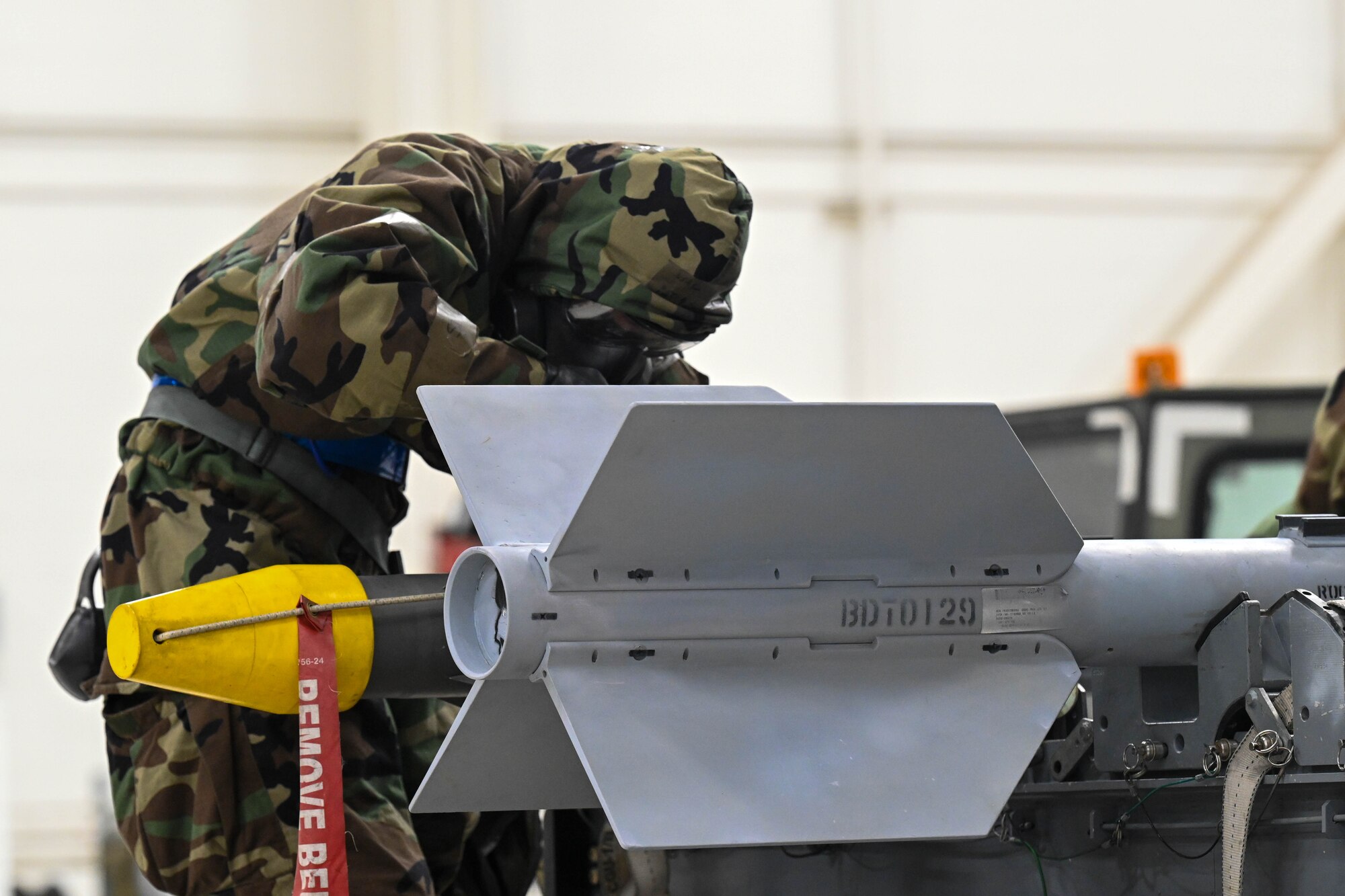 U.S. Air Force Airman 1st Class Aryan Guerrero, 3rd Munitions Squadron, competing for the 525 Fighter Generation Squadron prepares an inert AIM-9X Sidewinder to be loaded into the side internal Weapons bay of an F-22 Raptor during the bomb portion of a load competition on Joint Base Elmendorf-Richardson, Alaska, Jan. 10, 2025.