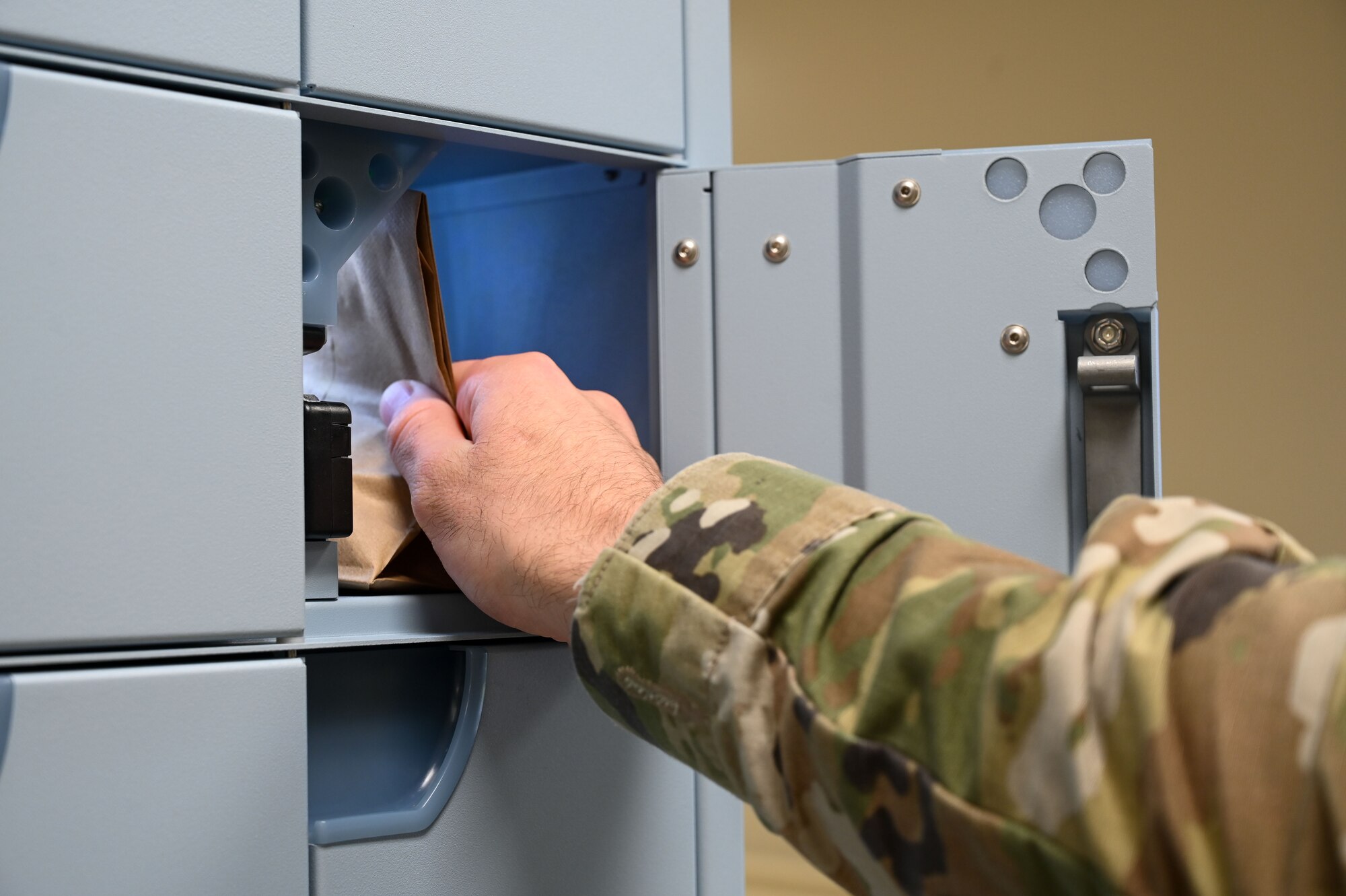 A U.S. Air Force Airman pulls a prescription out of the ScriptCenter locker at the 36th Medical Group on Andersen Air Force Base, Guam, Jan. 22, 2025. The ScriptCenter is a safe and secure locker system for prescription refill pick-ups and is available to all Tricare beneficiaries. (U.S. Air Force photo by Airman 1st Class Natasha Ninete)
