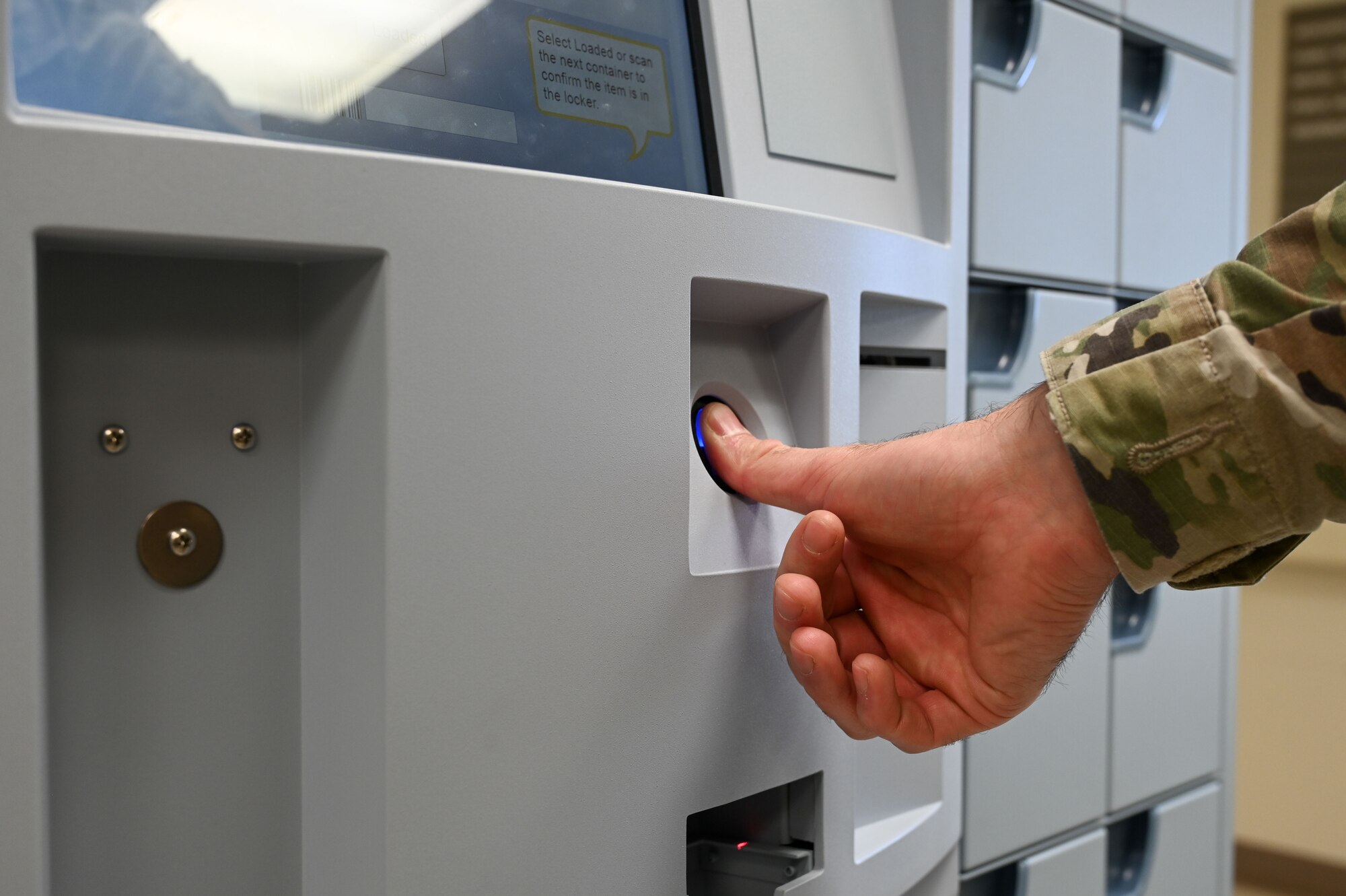 A U.S. Air Force Airman scans his fingerprint at the new ScriptCenter at the 36th Medical Group on Andersen Air Force Base, Guam, Jan. 22, 2025. The ScriptCenter is a safe and secure locker system for prescription refill pick-ups and is available to all Tricare beneficiaries. (U.S. Air Force photo by Airman 1st Class Natasha Ninete)