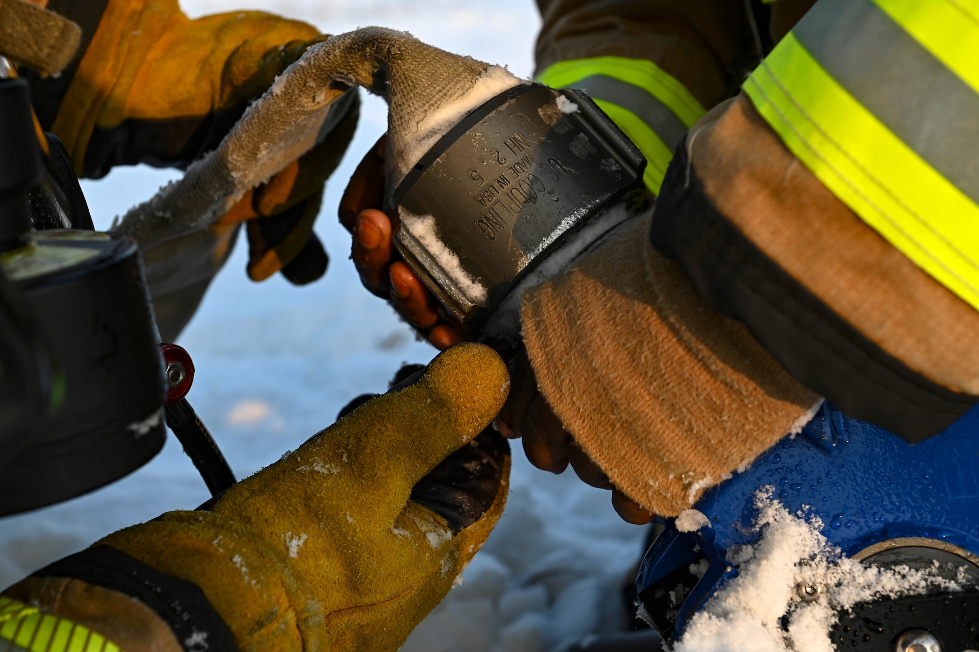 U.S. Air Force Staff Sgt. Austin James, 8th Civil Engineer Squadron firefighter, and Senior Airman Benjamin McEntire, 8th CES firefighter, attach a firehose to a defensive attack master stream during Beverly Pack 25-1.