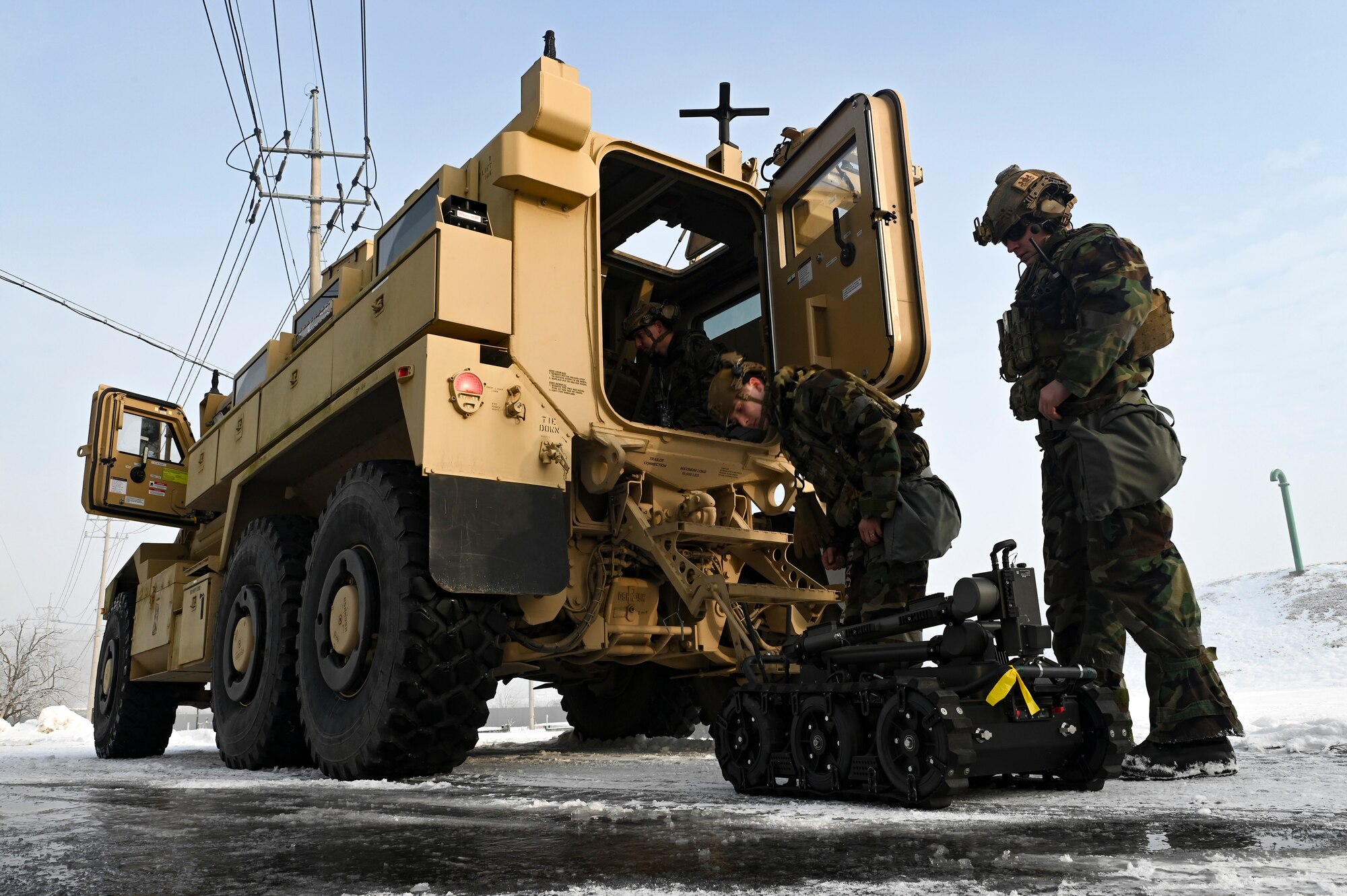Senior Airman Shae Barnard, 8th Civil Engineer Squadron explosive ordnance disposal primary team member, Airman First Class Cameron Poe, 8th CES EOD secondary team member, and U.S. Air Force Staff Sgt. Brian Price, 8th CES EOD team leader, set up a man transportable robotic system during Beverly Pack 25-1.
