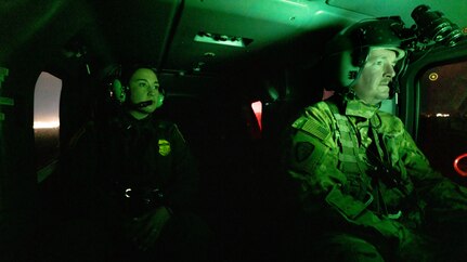 A U.S. Border Patrol agent alongside U.S. Soldiers with Bravo Company, 3rd Battalion, 140th Aviation Regiment assigned to Task Force Sentinel, conduct aerial reconnaissance