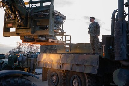 U.S. Marines with 1st Combat Engineer Battalion, 1st Marine Division, load concertina wire