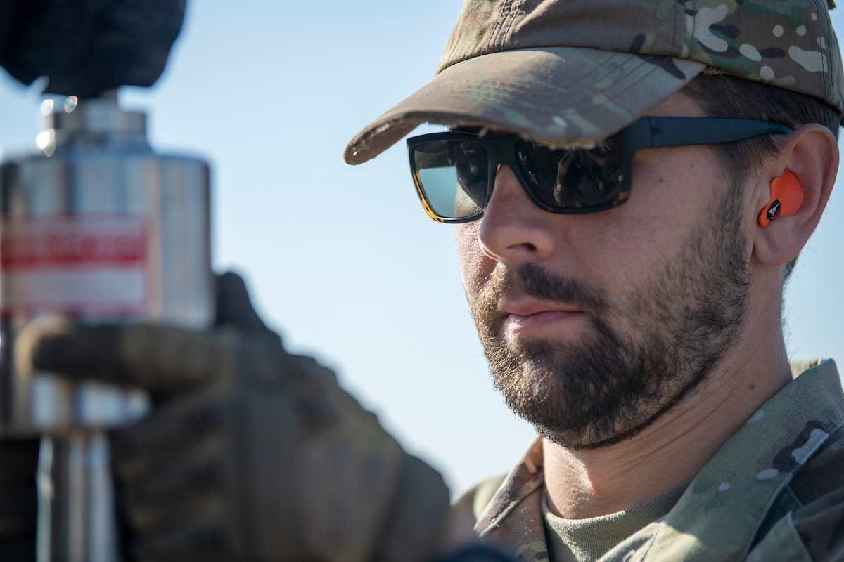 U.S. Air Force Staff Sgt. Samson Rice, 921st CRS landing zone safety officer, holds up a dynamic cone penetrometer in Rio Vista, California, Jan. 10, 2025.