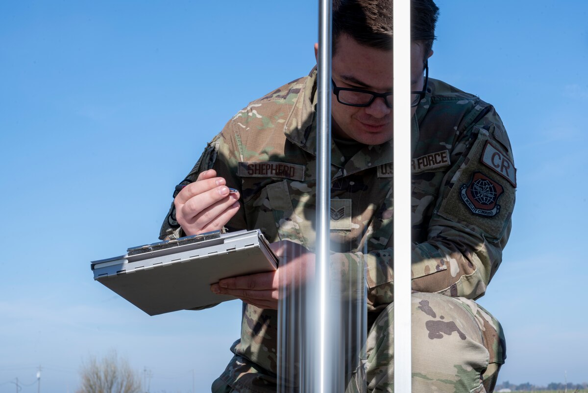 U.S. Air Force Staff Sgt. Wesley Shepherd, 821st Contingency Response Squadron landing zone safety officer, records soil integrity data from a dynamic cone penetrometer on an unprepared flight line in Rio Vista, California, Jan. 10, 2025.