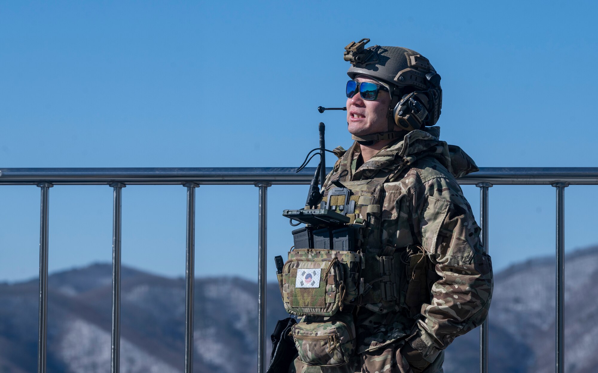 U.S. Air Force Maj. Anthony Shinn, 607th Air Support Operations Group executive officer, searches the sky for inbound aircraft during bilateral training at Pilsung Range in Gangwon Province, Republic of Korea, Jan. 15, 2025. TACPs direct airstrikes and close air support from the ground using various methods of communication with the pilots in the air. This bilateral training ensures readiness and combined strength between allies. (U.S. Air Force photo by Staff Sgt. Ashley N. Mikaio)