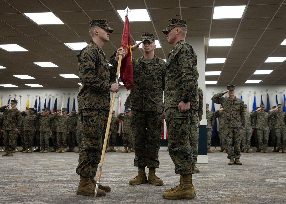 U.S Marine Corps Maj. J.D. Walker, left, the oncoming fire support coordinator of Fire Support Battery, 10th Marine Regiment, 2d Marine Division, receives the colors from Maj. Matthew Simpson, the outgoing fire support coordinator of Fire Support Battery, 10th Marine Regiment, 2d Marine Division during a change of command ceremony on Camp Lejeune, North Carolina, Jan. 10, 2025. The change of command ceremony is a tradition that symbolizes the transfer of authority, responsibility and accountability of the Marines and Sailors in that unit. (U.S. Marine Corps photo by Lance Cpl. Judith Ann Lazaro)