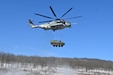 A Marine CH-53 Super Stallion helicopter from Marine Heavy Helicopter Squadron 772 out of Joint Base Maguire-Dix-Lakehurst, New Jersey, air-lifts a decommissioned Army Stryker vehicle to Fort Indiantown Gap’s impact area Jan. 22, 2025. A team of Air Force sling-load specialists from the 621st Contingency Response Group sling-loaded the Stryker to the helicopter. (Pennsylvania National Guard photo by Brad Rhen)