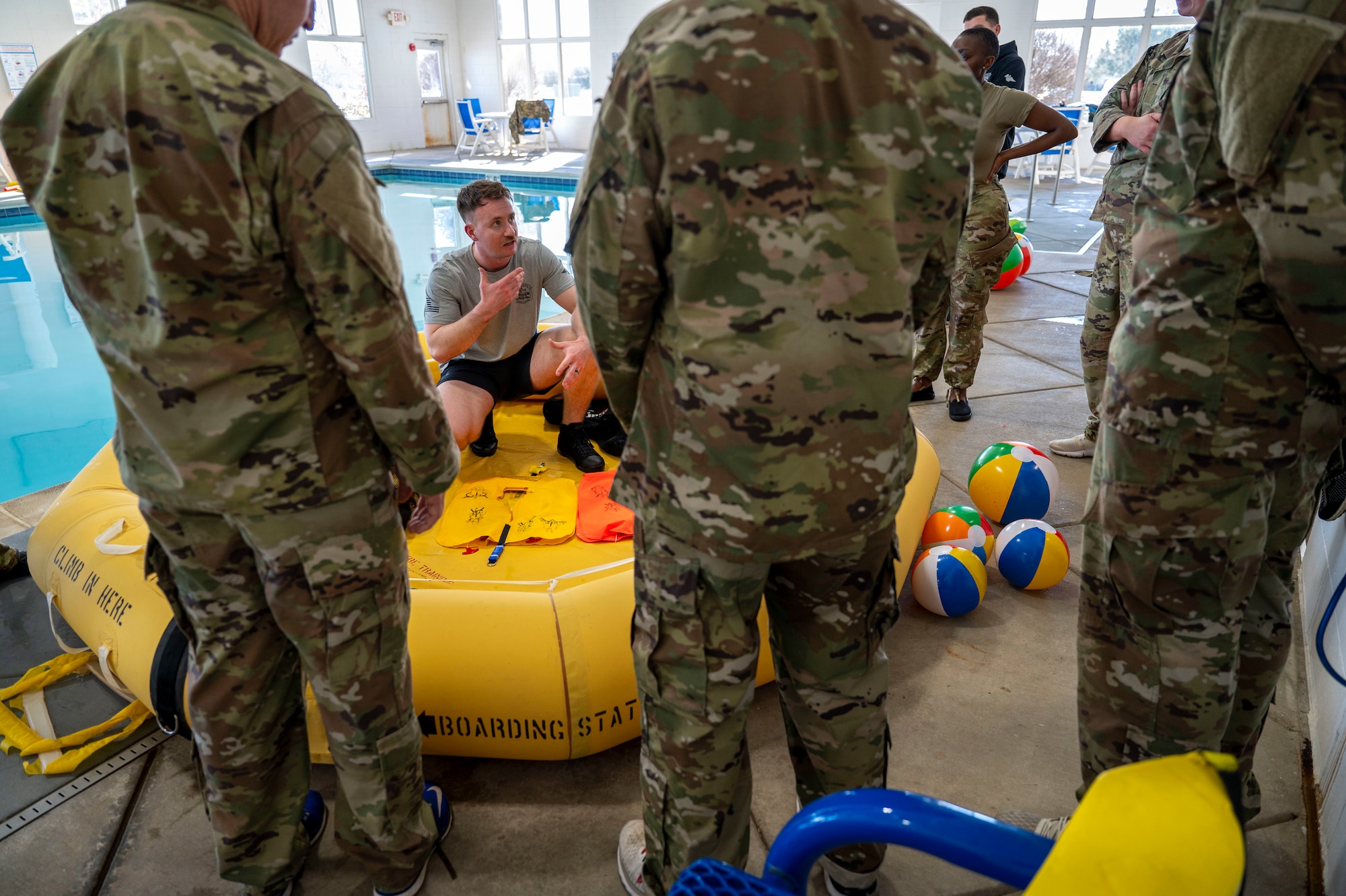 Senior Airman Christopher VanHeuvelen, a survival, evasion, resistance, escape specialist, provides water survival training to Airmen at Scott Air Force Base on Jan. 16, 2025. SERE specialist duties range from instruction of formal courses to direct operational unit support at locations in continental U.S. and overseas. (U.S. Air Force photo by Rachel Sansano)