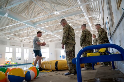 Senior Airman Christopher VanHeuvelen, a survival, evasion, resistance, escape specialist, instructs Airmen in water survival techniques at Scott Air Force base on Jan. 16, 2025. SERE specialists are responsible for equipping Airmen with the knowledge, tools, and strategies necessary to survive and safely return from any mission, regardless of the circumstances. (U.S. Air Force photo by Rachel Sansano)