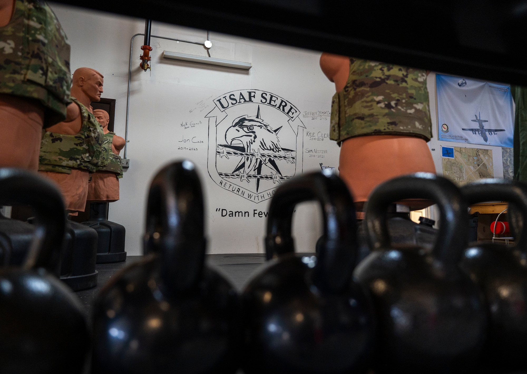 Kettlebells sit on a shelf at the survival, evasion, resistance, escape shop on Scott Air Force Base, Dec. 11, 2024. SERE is responsible for equipping Airmen with the knowledge, tools, and strategies necessary to survive and safely return from any mission, regardless of the circumstances. (U.S. Air Force photo by Rachel Sansano)