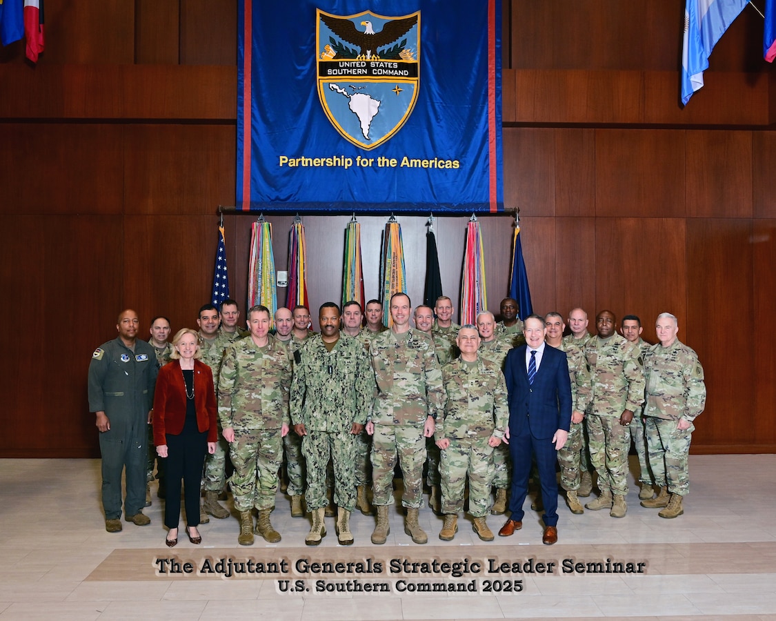 A group of military and civilian leaders posing for a group photo.