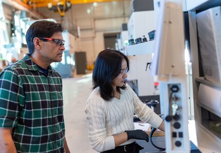 Jim Hook, an Accelerated Training for Defense Manufacturing (ATDM)  instructor, teaches a student how to use a Haas CNC machine at the newly opened National Training Center in Danville, Virginia.