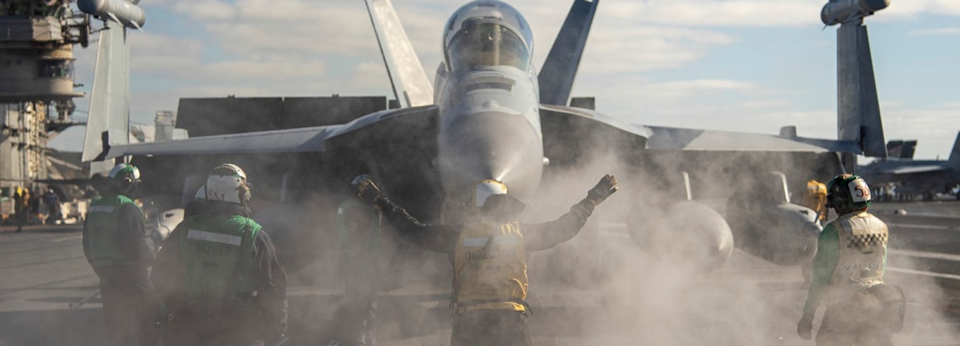 A Sailor directs an E/A-18G Growler from the "Cougars" of Electronic Attack Squadron (VAQ) 139 on the flight deck of the aircraft carrier USS Nimitz (CVN 68) in the Pacific Ocean, Jan. 18, 2025.