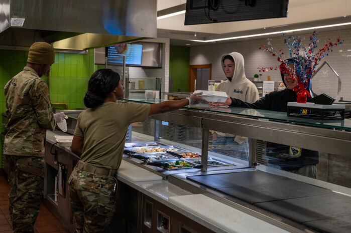 Airmen serve and receive food