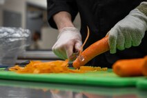An Airman prepares food