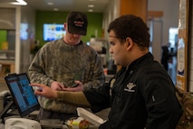 An Airman processes a food order