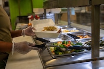 An Airman serves food