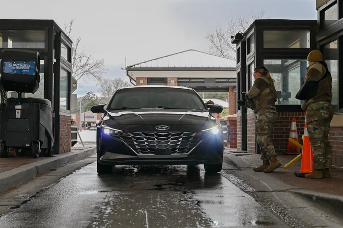 Two Airman at the front gate of Joint Base Charleston checking IDs