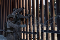 U.S. Marines with 1st Combat Engineer Battalion, 1st Marine Division, deploy concertina wire at an undisclosed location on the southern border, Jan. 23, 2025. U.S. Northern Command is working together with the Department of Homeland Security with the emplacement of temporary physical barriers to add additional security that will curtail illegal border crossings. (U.S. Marine Corps photo by Cpl. Logan Courtright)