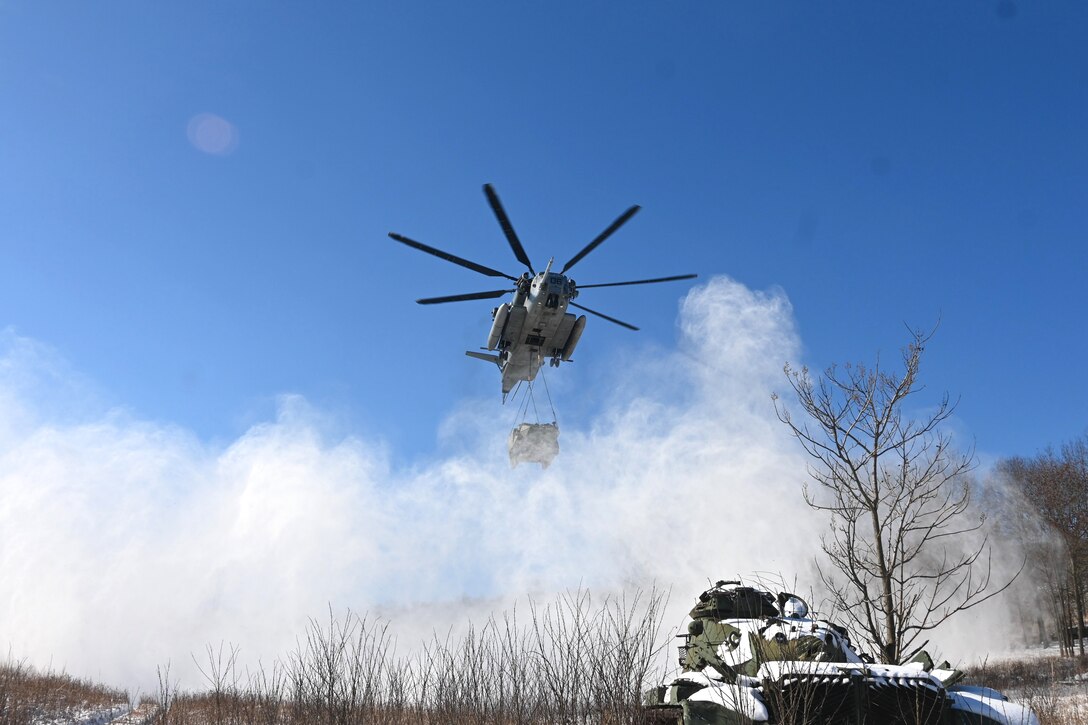 A Marine CH-53 Super Stallion helicopter from Marine Heavy Helicopter Squadron 772 out of Joint Base Maguire-Dix-Lakehurst, New Jersey, air-lifts a decommissioned Army Stryker vehicle to Fort Indiantown Gap’s impact area Jan. 22, 2025. A team of Air Force sling-load specialists from the 621st Contingency Response Group sling-loaded the Stryker to the helicopter. (Pennsylvania National Guard photo by Brad Rhen)