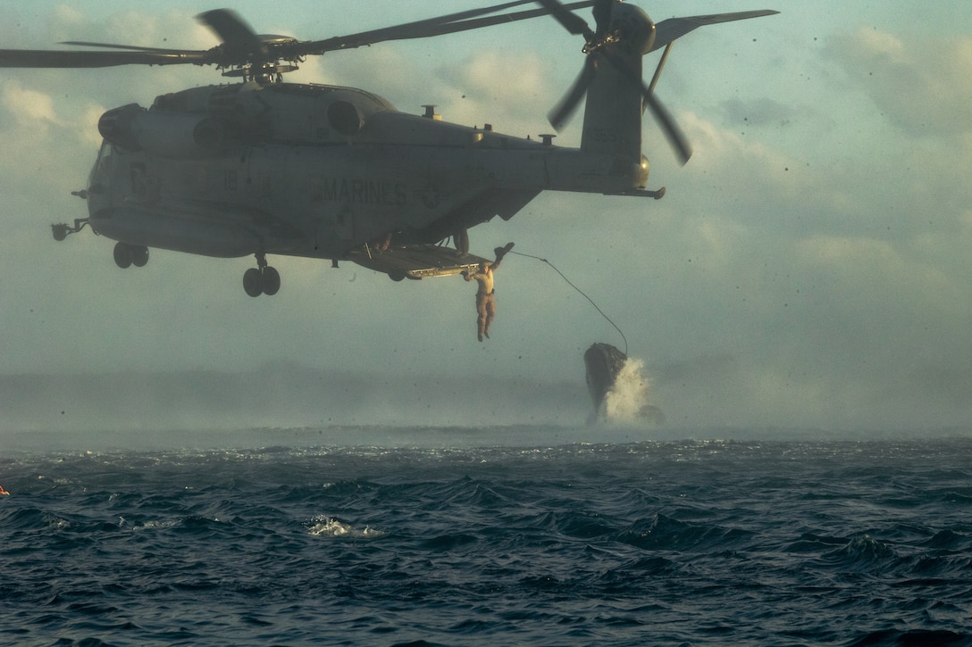 A U.S. Marine with Force Reconnaissance Platoon, Maritime Raid Force, 31st Marine Expeditionary Unit, jumps from a CH-53E Super Stallion assigned to Marine Medium Tiltrotor Squadron 262 (Rein.) during helocast training at Kin Blue Beach Training Area, Okinawa, Japan, Jan. 17, 2025. This training enhances airborne techniques and enables Marines to insert personnel into a body of water from an aircraft. The 31st MEU, the Marine Corps’ only continuously forward-deployed MEU, provides a flexible and lethal force, ready to perform a wide range of military operations as the premiere crisis response force in the Indo-Pacific region. (U.S. Marine Corps photo by Pfc. Skilah Sanchez)