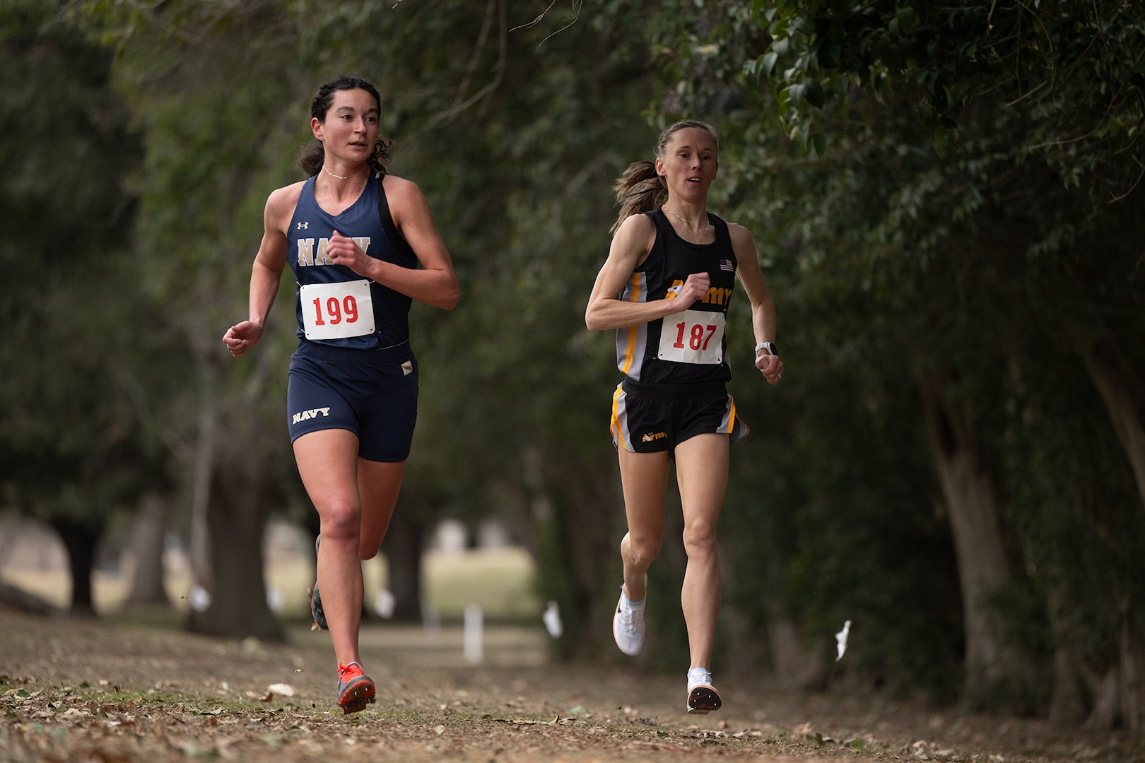 Army Sgt. Colett Rampf-Cribbs passes Navy Ensign Elizabeth Sullivan during the 2025 Armed Forces Men’s and Women’s Cross Country Championship at Windcrest Golf Club in Windcrest, Texas, on Jan. 25, 2025. (DoD photo by EJ Hersom)