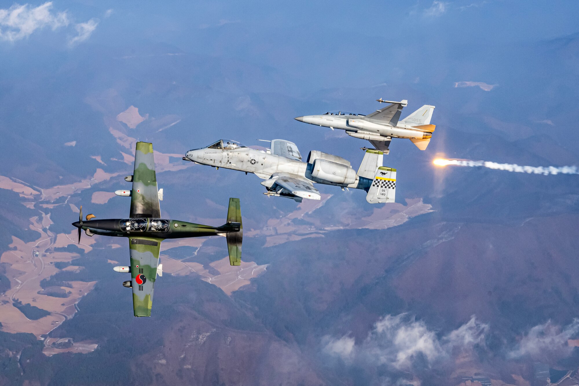 A Republic of Korea Air Force FA-50 Golden Eagle, a U.S. Air Force A-10 Thunderbolt II, and a ROKAF KA-1 Woongbi conduct joint aerial operations during Buddy Squadron 25-4 over the Republic of Korea