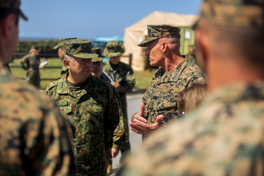 U.S. Marine Corps Lt. Gen. Roger Turner, commanding general of III Marine Expeditionary Force, communicates with Japan Ground Self-Defense Force Lt. Gen. Masayoshi Arai, commanding general of the Western Army, during exercise Resolute Dragon 24 at JGSDF Camp Yonaguni, Okinawa, Japan, August 4, 2024. RD 24 is an annual bilateral exercise in Japan that strengthens the command, control, and multi-domain maneuver capabilities of U.S. Marines in the III Marine Expeditionary Force and Japan Self-Defense Force personnel, with a focus on controlling and defending key maritime terrain. (U.S. Marine Corps photo by Lance Cpl. Matthew Morales)