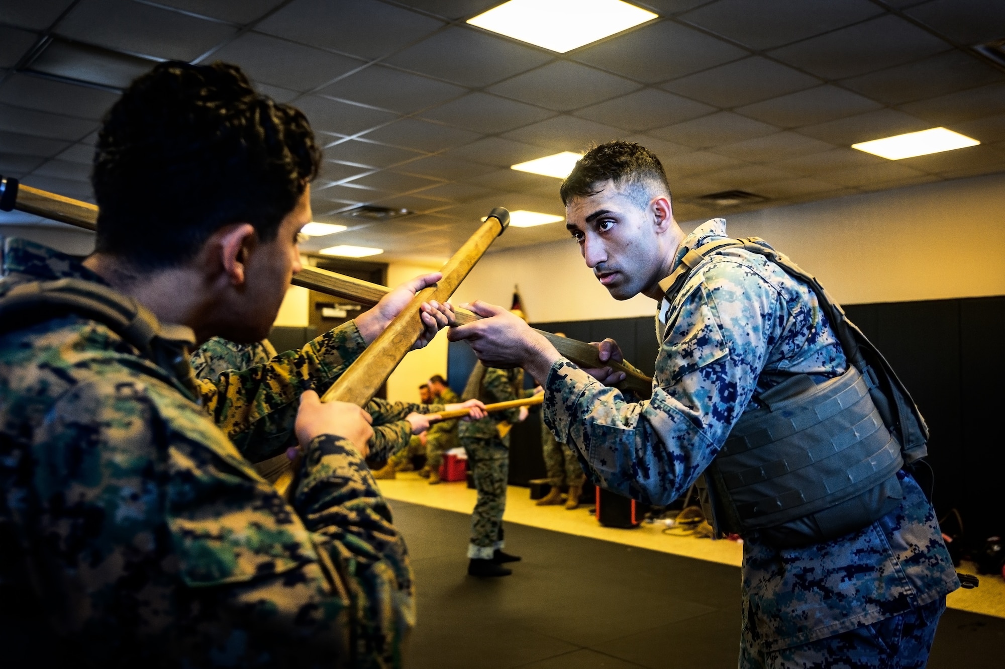 U.S. Marine Corps Cpl. Reed Lyons, Marine Aircraft Group 49 Marine Corps Martial Arts Program trainee and U.S. Marine Corps. Staff Sgt. Bryan Greenwood, MAG 49 MCMAP trainee, perform water-based exercises while at Joint Base McGuire-Dix-Lakehurst, N.J., Jan. 10, 2025. MCMAP is a combat system that combines existing and new hand-to-hand and close quarters combat techniques with morale, team-building functions and instruction in the warrior ethos. The techniques used by MCMAP vary in degrees of lethality allowing members to qualify and master up to six disciplines through continuation in the program. (U.S. Air Force photo by Senior Airman Matt Porter)