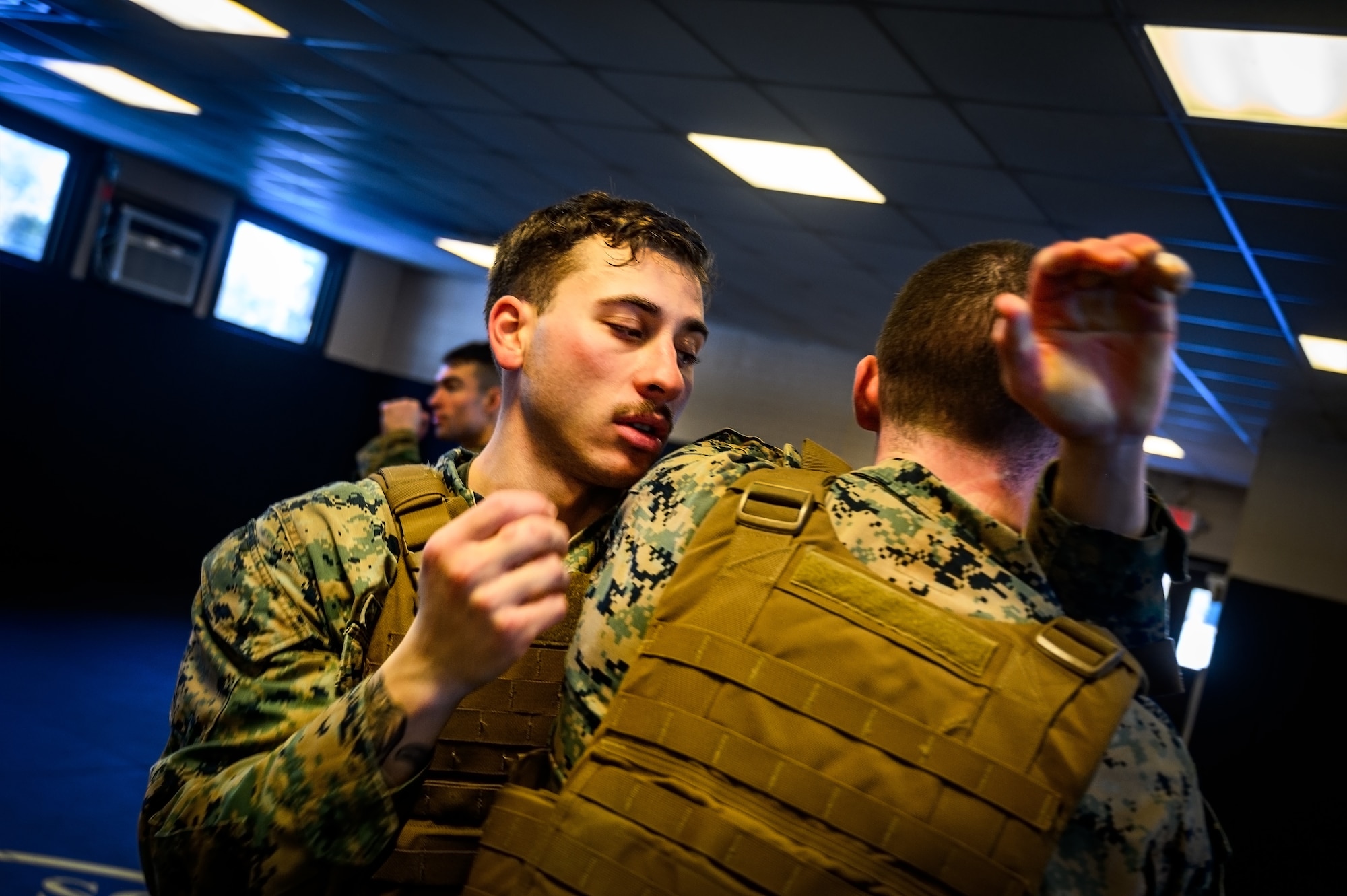 U.S. Marine Corps Cpl. Reed Lyons, Marine Aircraft Group 49 Marine Corps Martial Arts Program trainee and U.S. Marine Corps. Staff Sgt. Bryan Greenwood, MAG 49 MCMAP trainee, perform water-based exercises while at Joint Base McGuire-Dix-Lakehurst, N.J., Jan. 10, 2025. MCMAP is a combat system that combines existing and new hand-to-hand and close quarters combat techniques with morale, team-building functions and instruction in the warrior ethos. The techniques used by MCMAP vary in degrees of lethality allowing members to qualify and master up to six disciplines through continuation in the program. (U.S. Air Force photo by Senior Airman Matt Porter)