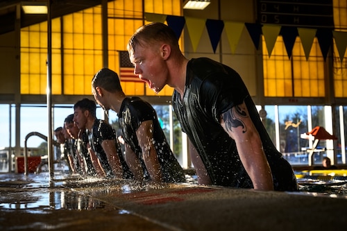 U.S. Marine Corps Cpl. Reed Lyons, Marine Aircraft Group 49 Marine Corps Martial Arts Program trainee and U.S. Marine Corps. Staff Sgt. Bryan Greenwood, MAG 49 MCMAP trainee, perform water-based exercises while at Joint Base McGuire-Dix-Lakehurst, N.J., Jan. 10, 2025. MCMAP is a combat system that combines existing and new hand-to-hand and close quarters combat techniques with morale, team-building functions and instruction in the warrior ethos. The techniques used by MCMAP vary in degrees of lethality allowing members to qualify and master up to six disciplines through continuation in the program. (U.S. Air Force photo by Senior Airman Matt Porter)