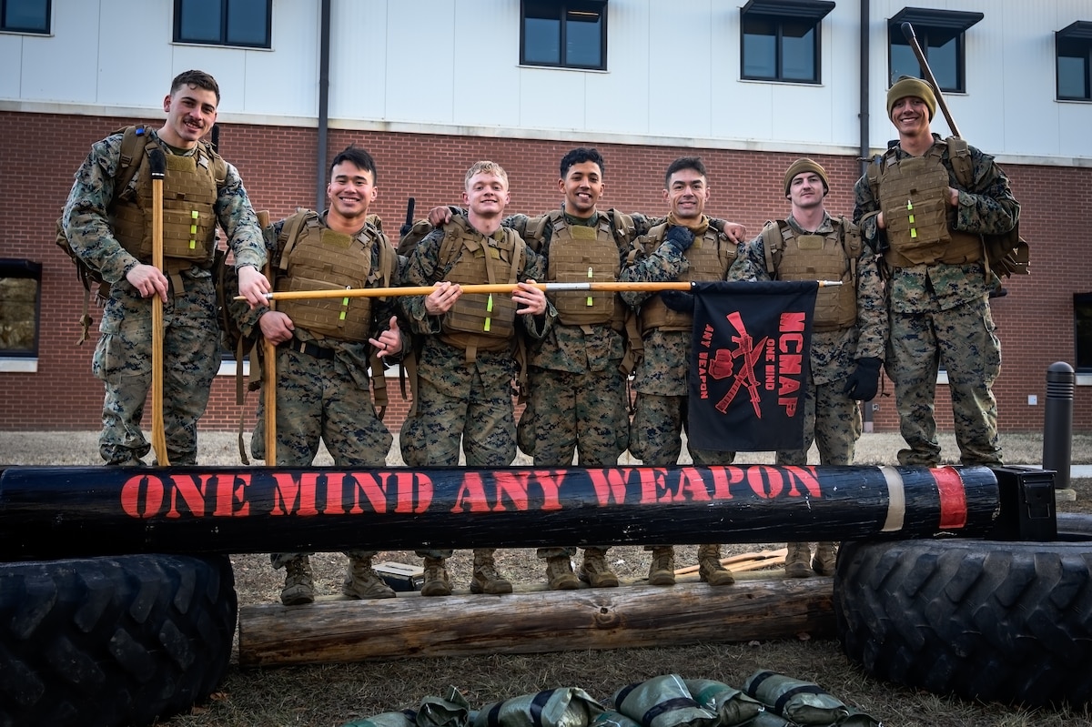 U.S. Marines assigned to Marine Aircraft Group 49 pose for a group photo during the Marine Corps Martial Arts Program at Joint Base McGuire-Dix-Lakehurst, N.J., Jan. 16, 2025. MCMAP is a combat system that combines existing and new hand-to-hand and close quarters combat techniques with morale, team-building functions and instruction in the warrior ethos. The techniques used by MCMAP vary in degrees of lethality allowing members to qualify and master up to six disciplines through continuation in the program. (U.S. Air Force photo by Senior Airman Matt Porter)