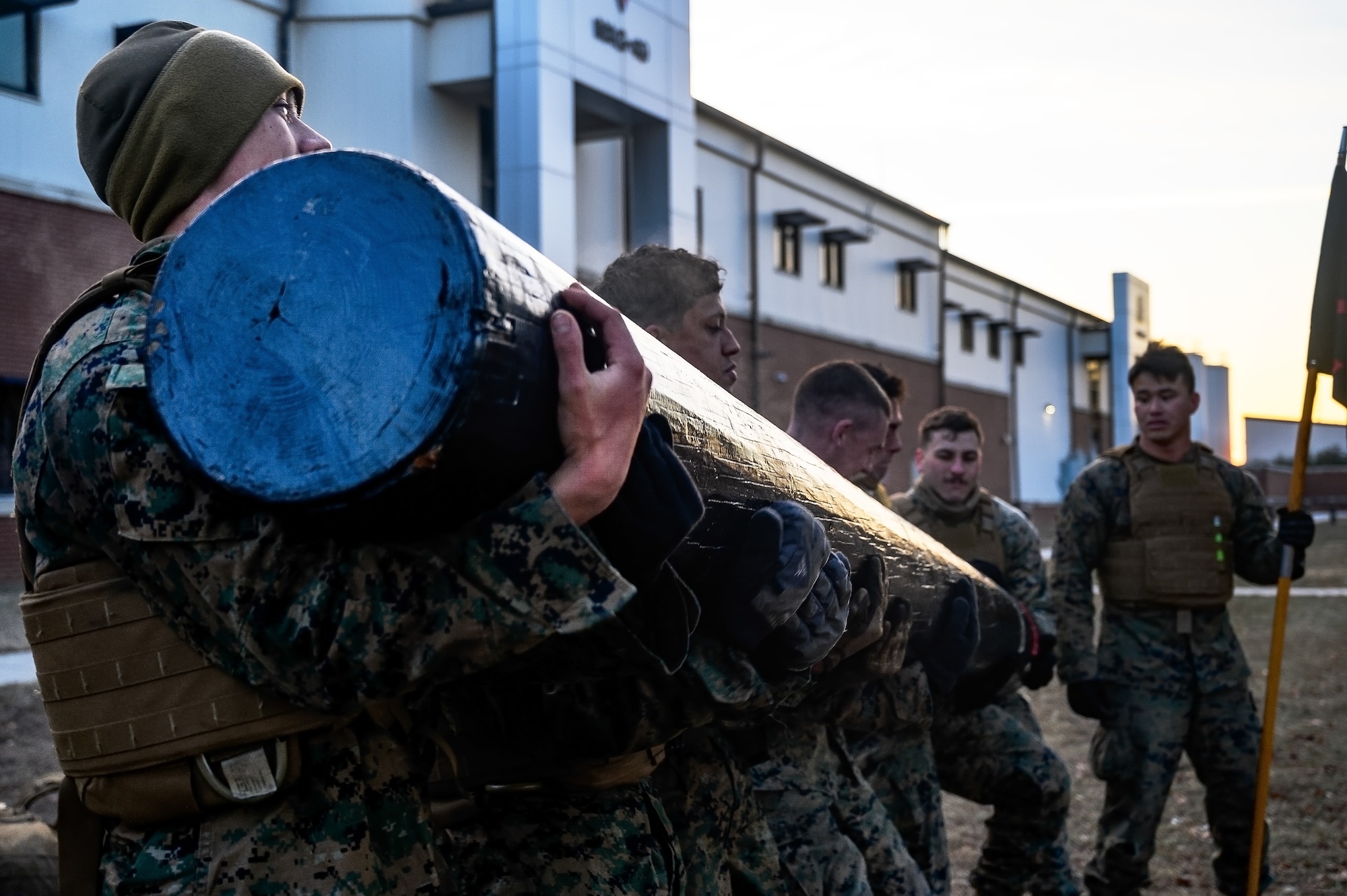 U.S. Marines assigned to Marine Aircraft Group 49 lift a log during the Marine Corps Martial Arts Program at Joint Base McGuire-Dix-Lakehurst, N.J., Jan. 16, 2025. MCMAP is a combat system that combines existing and new hand-to-hand and close quarters combat techniques with morale, team-building functions and instruction in the warrior ethos. The techniques used by MCMAP vary in degrees of lethality allowing members to qualify and master up to six disciplines through continuation in the program. (U.S. Air Force photo by Senior Airman Matt Porter)