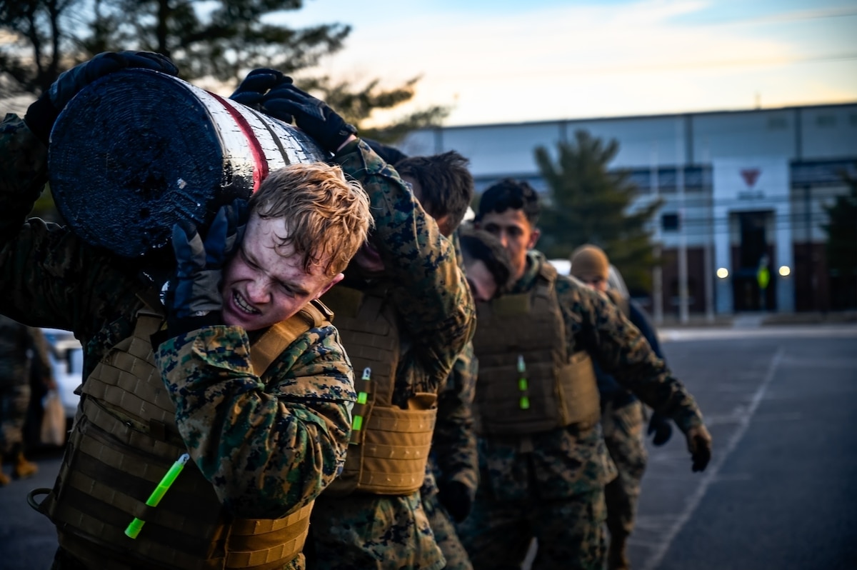 U.S. Marines assigned to Marine Aircraft Group 49 lift a log during the Marine Corps Martial Arts Program at Joint Base McGuire-Dix-Lakehurst, N.J., Jan. 16, 2025. MCMAP is a combat system that combines existing and new hand-to-hand and close quarters combat techniques with morale, team-building functions and instruction in the warrior ethos. The techniques used by MCMAP vary in degrees of lethality allowing members to qualify and master up to six disciplines through continuation in the program. (U.S. Air Force photo by Senior Airman Matt Porter)