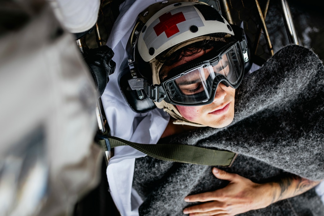 Sailors carry Intelligence Specialist 2nd Class Isaac Eaker, from La Jolla, California, assigned to intelligence department’s satellite imagery analyzation division, to an elevator on the flight deck during a medical drill aboard Nimitz-class aircraft carrier USS George Washington (CVN 73) while underway in the Pacific Ocean.